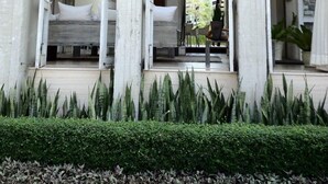 A modern hotel with a balcony, large windows, and a well-maintained garden. - Away Baan Nub Kluen Beachfront at HuaHin (Hua Hin)