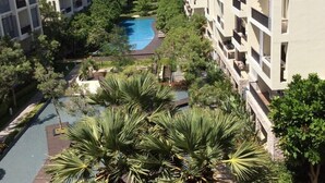 A resort with multiple-story buildings, a central swimming pool, and lush greenery. - Away Baan Nub Kluen Beachfront at HuaHin (Hua Hin)