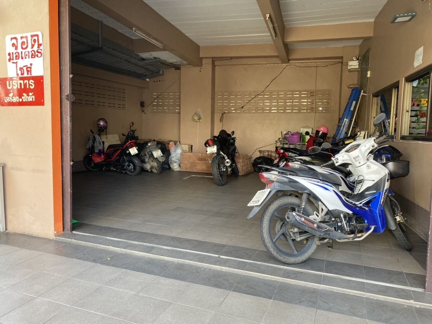 A motorcycle garage with several motorcycles parked inside.