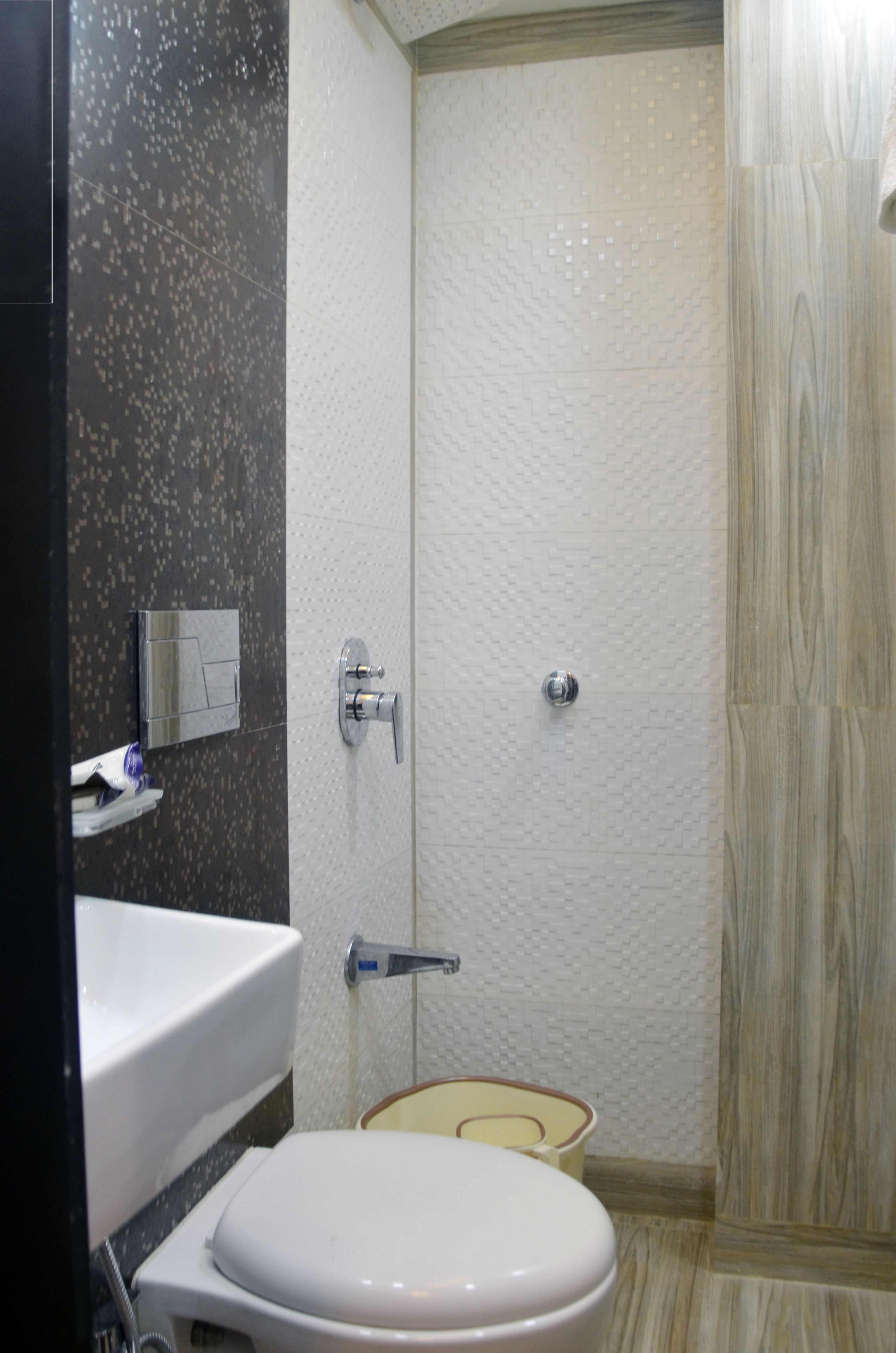 A bathroom with a toilet, sink, and shower.
