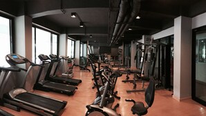 A gym with treadmills, elliptical machines, and weightlifting equipment. - Huahin Terminal (Hua Hin)