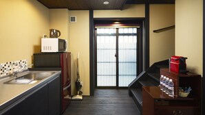 A compact kitchen with a sink, microwave, and a coffee machine.