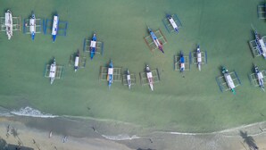 An aerial view of a beach with multiple model airplanes arranged in rows. - Coral Cliff Hotel (El Nido)