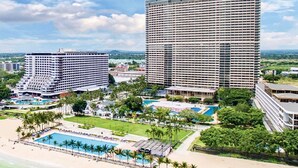 A hotel with multiple buildings, a large pool area, and surrounding greenery. - Ambassador City Jomtien Pattaya - Ocean Wing (Sattahip)