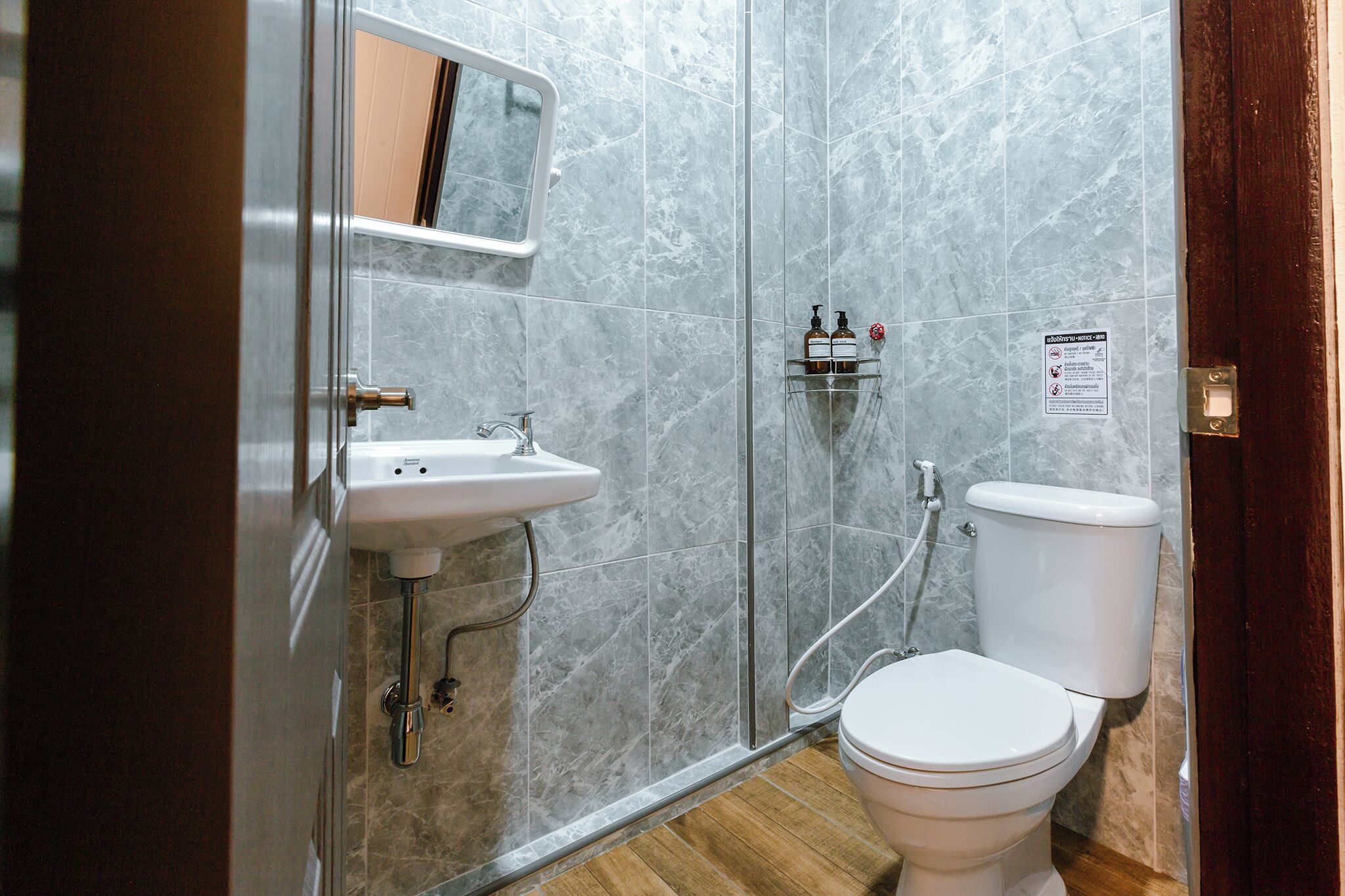 A bathroom with a sink, toilet, and shower.