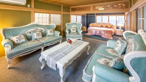 Una habitación tradicional con un conjunto de sofá, una cama y una mesa.