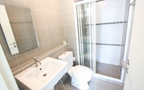 A bathroom with a sink, toilet, and glass shower enclosure. - D Condo Sign Chiang Mai R628 (Chiang Mai)