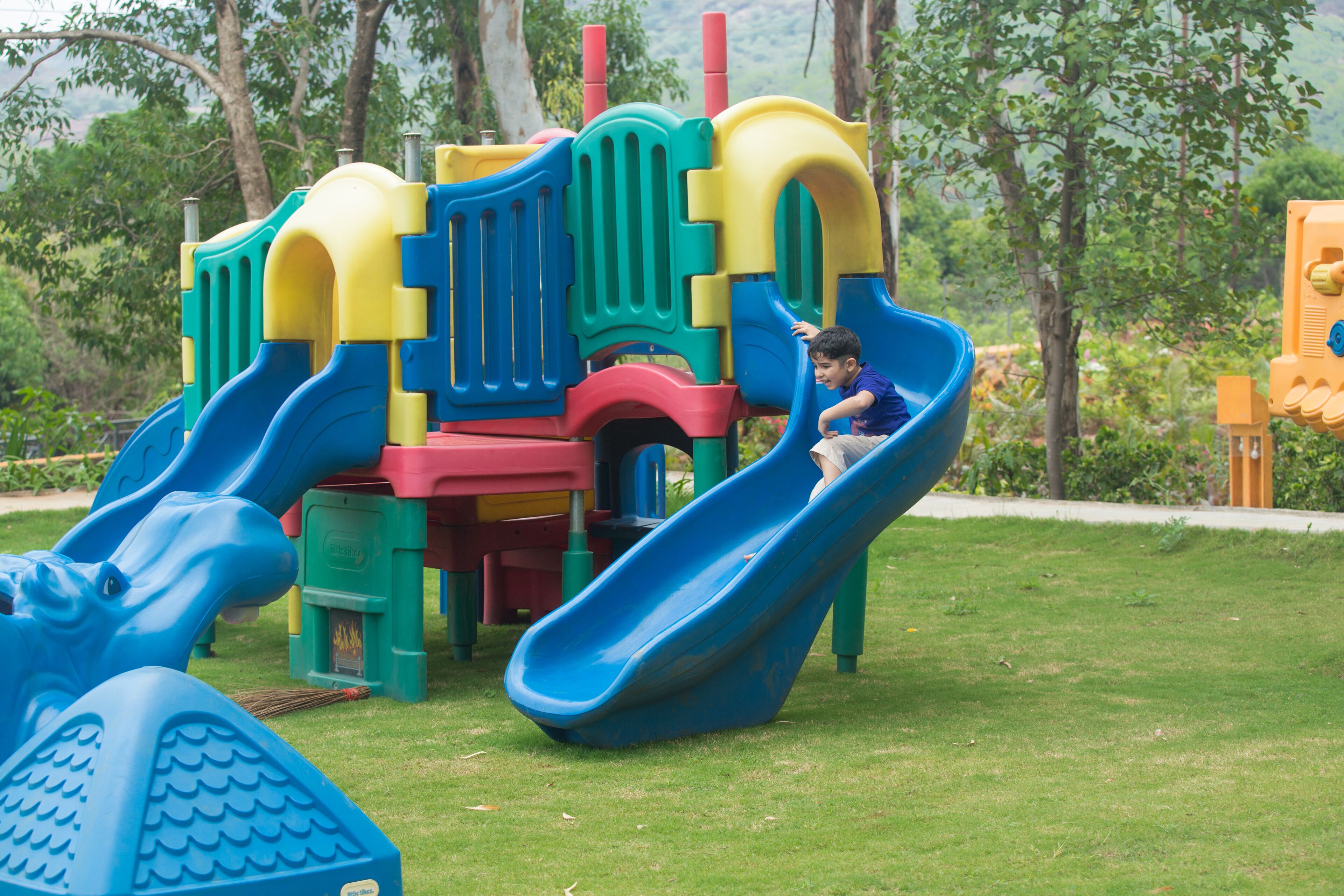 A playground with multiple slides and climbing structures.