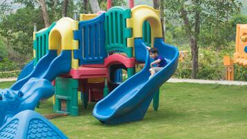 A playground with multiple slides and climbing structures.