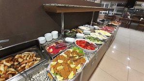 A buffet with various food items including meats, salads, and fruits. - Hotel Altinnal (Izmit)