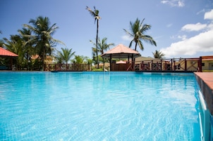 Una piscina al aire libre, sombrillas, tumbonas