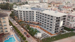 A multi-story hotel with a rooftop pool, outdoor seating, and a swimming pool. - Kleopatra Dreams Beach Hotel (Alanya)