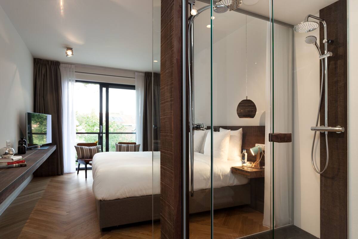 superior double room | bathroom | rainfall showerhead, designer toiletries, hair dryer, towels