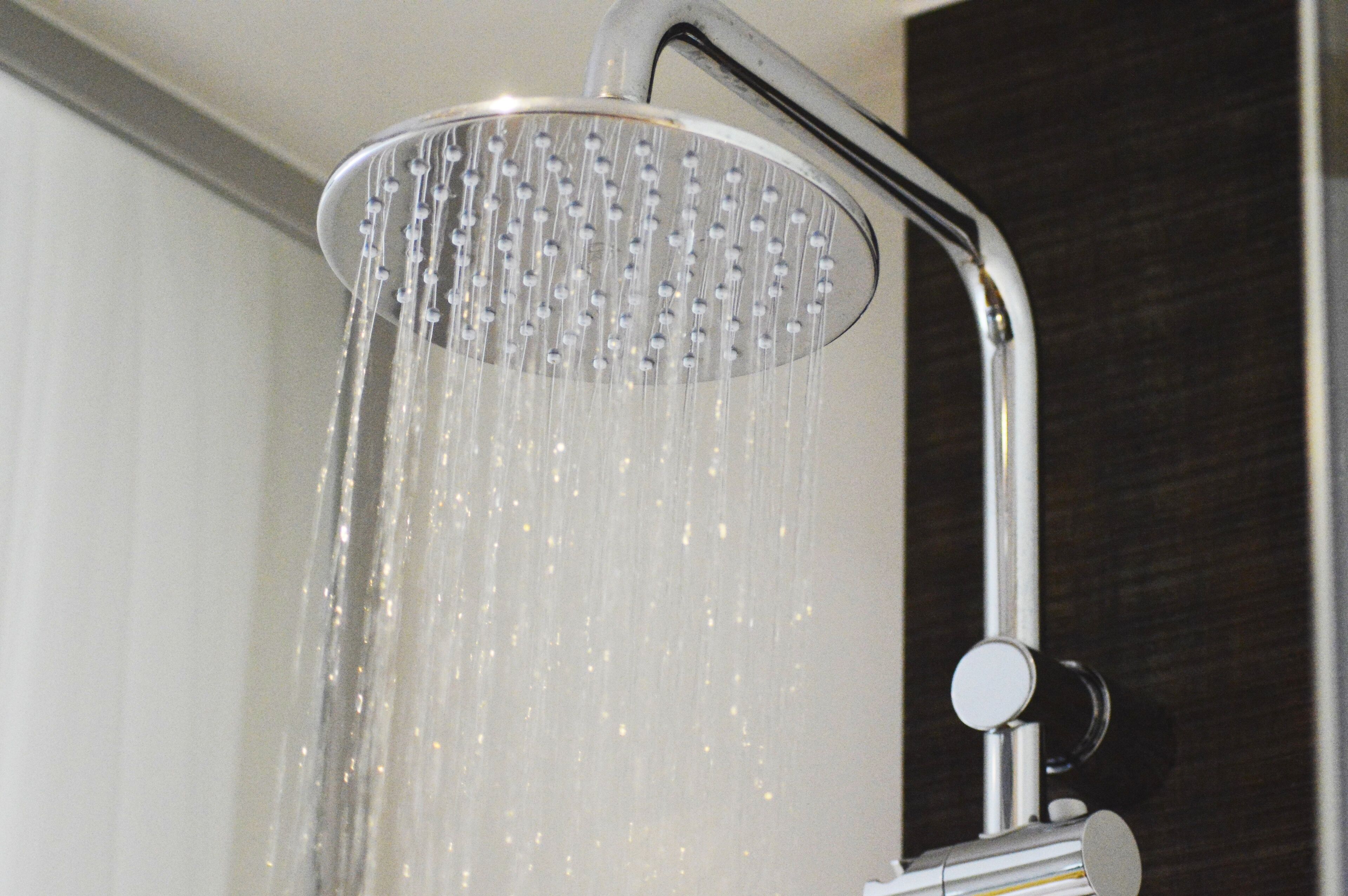 A showerhead with water flowing from it.