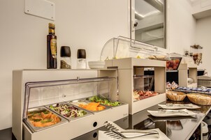 A buffet setup with various food items and condiments.