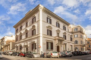 A historic building with classical architecture, featuring multiple windows and a prominent entrance.