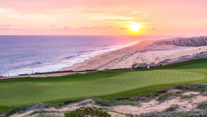 A coastal golf course with a view of the ocean and sunset. - Quivira Los Cabos Condos & Homes - Vacation Rentals (Cabo San Lucas)