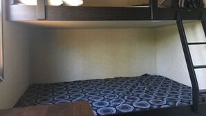 A bunk bed with a ladder, a patterned mattress, and a pillow on the top bunk. - QuickStay - Heavenly Cottage (Beautiful Lake Views) (Bracebridge)