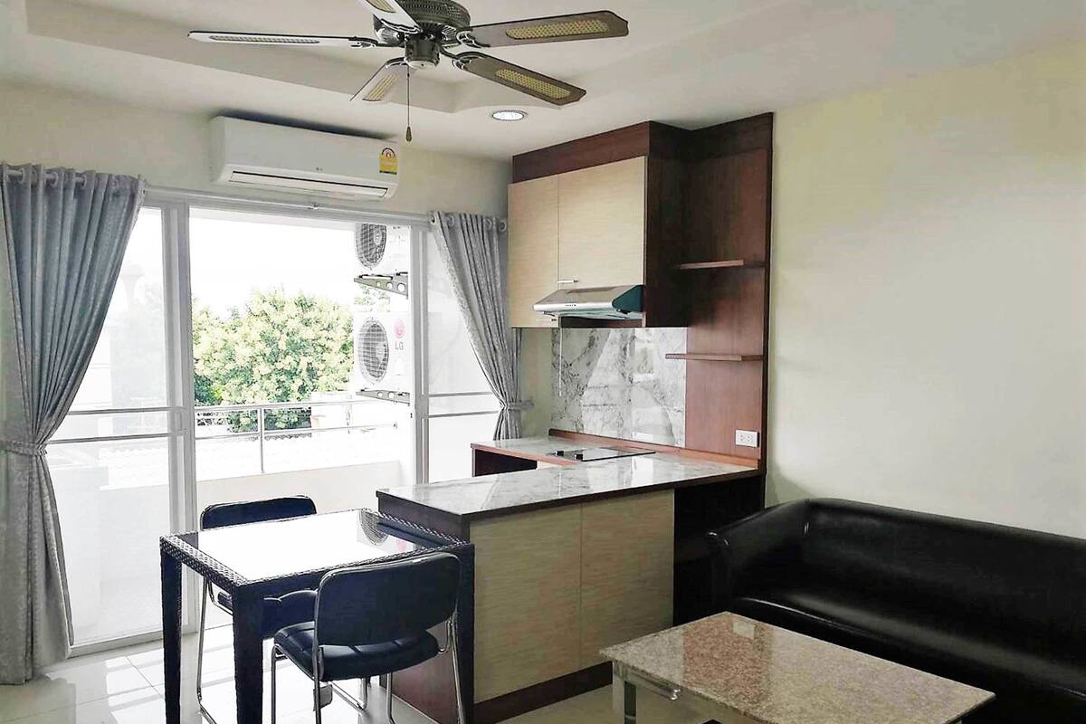 A modern apartment with a kitchen, dining area, and living space.