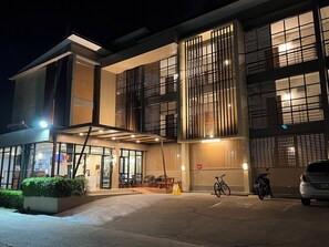 A multi-story building with large windows and a covered entrance area. - K2 Living Uttaradit (Uttaradit)