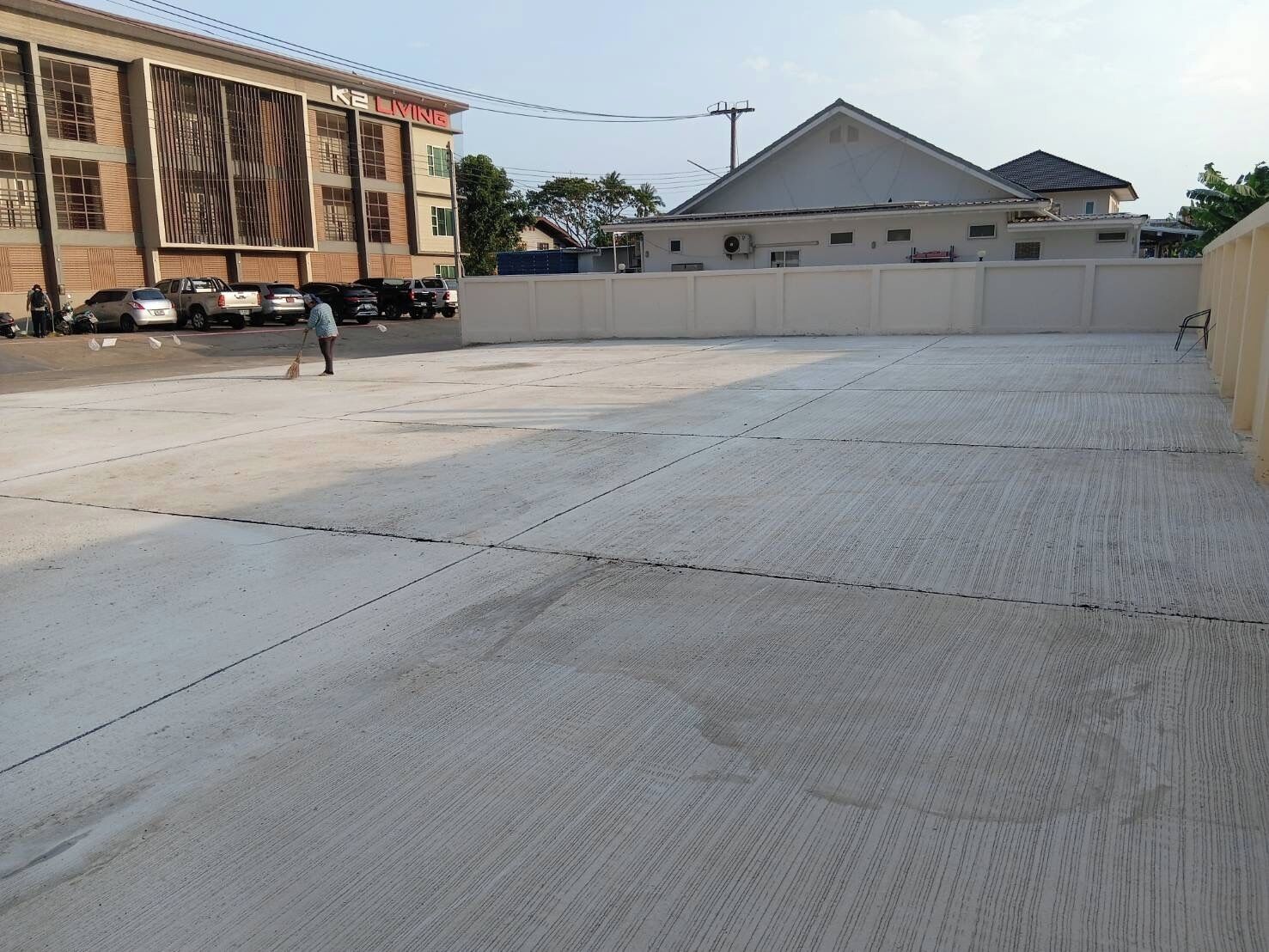 A large, open concrete area with a building labeled "K2 LIVING" in the background.