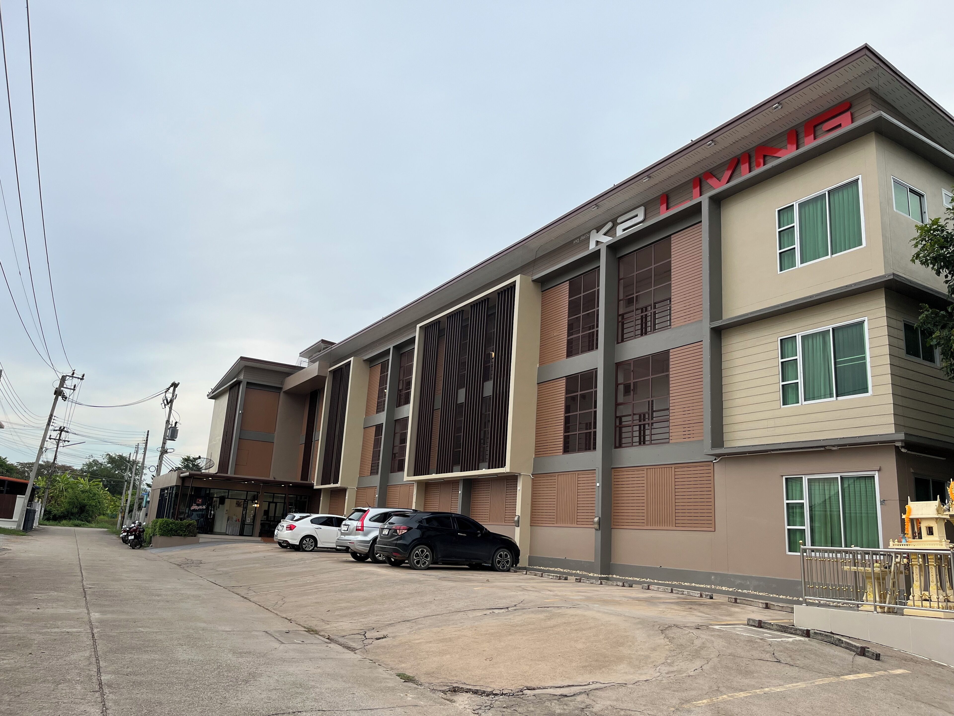 A multi-story building with a modern architectural design, featuring large windows and a prominent signage.