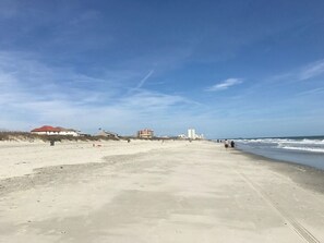 Guests can enjoy a serene beach experience with a clear view of the surrounding landscape.
