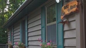 A house with green shutters and a sign that reads "Maple Ridge".