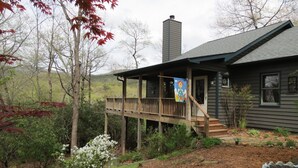 A wooden house with a covered porch, a chimney, and a flag. - Mountain VIEW! -  Private-Romantic -Secluded -WiFi (Ellijay)
