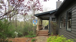 A house with a wooden deck, stone pathway, and a garden with various plants and flowers. - Mountain VIEW! -  Private-Romantic -Secluded -WiFi (Ellijay)
