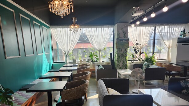 A restaurant interior with tables, chairs, and a chandelier. - Gunsan La Siesta Hotel (Gunsan)