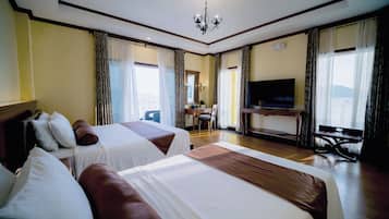 Deluxe Triple Room, Ocean View | Minibar, in-room safe, desk, bed sheets