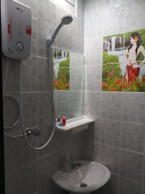 A bathroom with a shower, a sink, and a mirror. - Kata S.T. House (Karon)