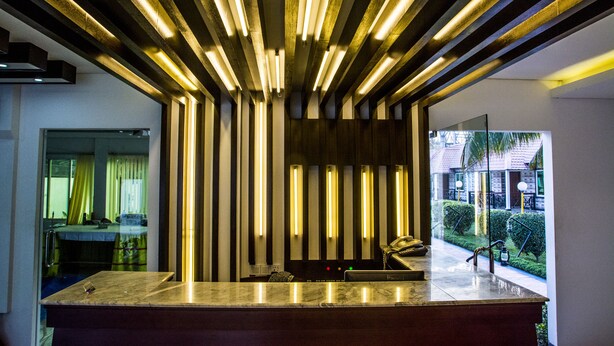 A modern kitchen with a marble countertop and a built-in oven. - Nandan Village Resort (Chandra)