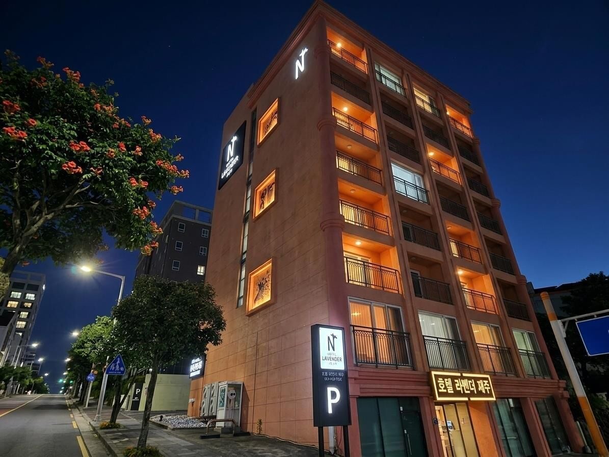 A multi-story hotel with a prominent 'N' sign, balconies, and a 'P' parking sign.