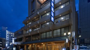 A multi-story hotel with a prominent sign, large windows, and a covered entrance area. - Subaruyado Yoshino (Tokushima)