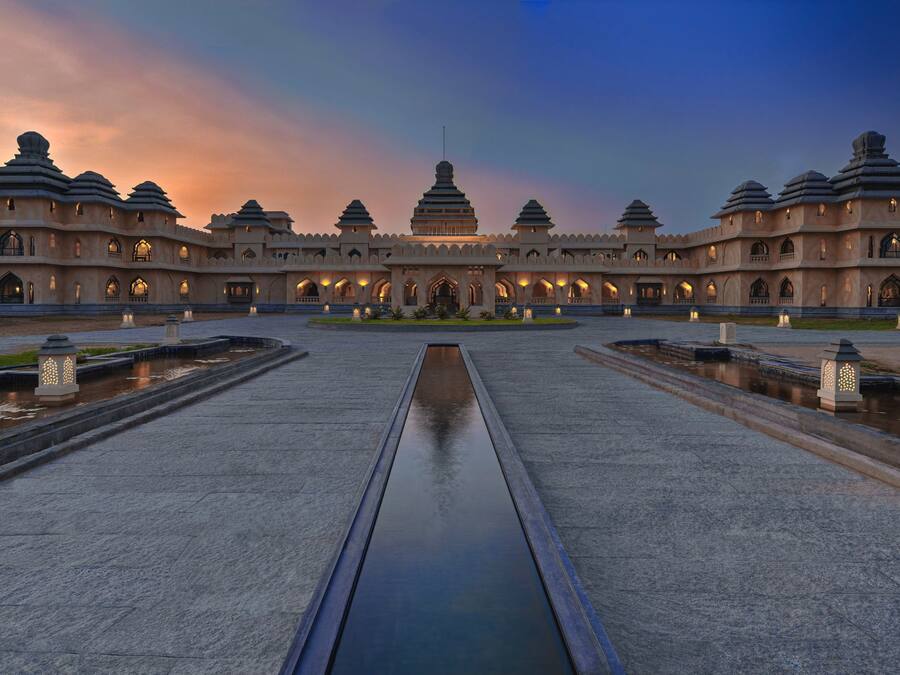 A large, multi-tiered building with a central water feature and multiple lanterns.