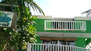 A two-story building with a green and white facade, a balcony, and a sign reading "Beach Bites". - Bluewaves Beach House (Boracay Island)