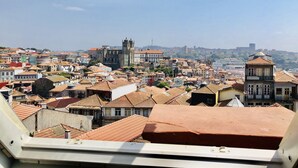 A cityscape with a prominent church and various buildings. - YOUROPO - Clérigos (Porto)