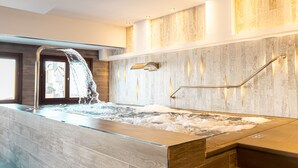 A modern spa area with a hot tub, a glass enclosure, and a wooden wall. - Catalonia Ronda (Ronda)