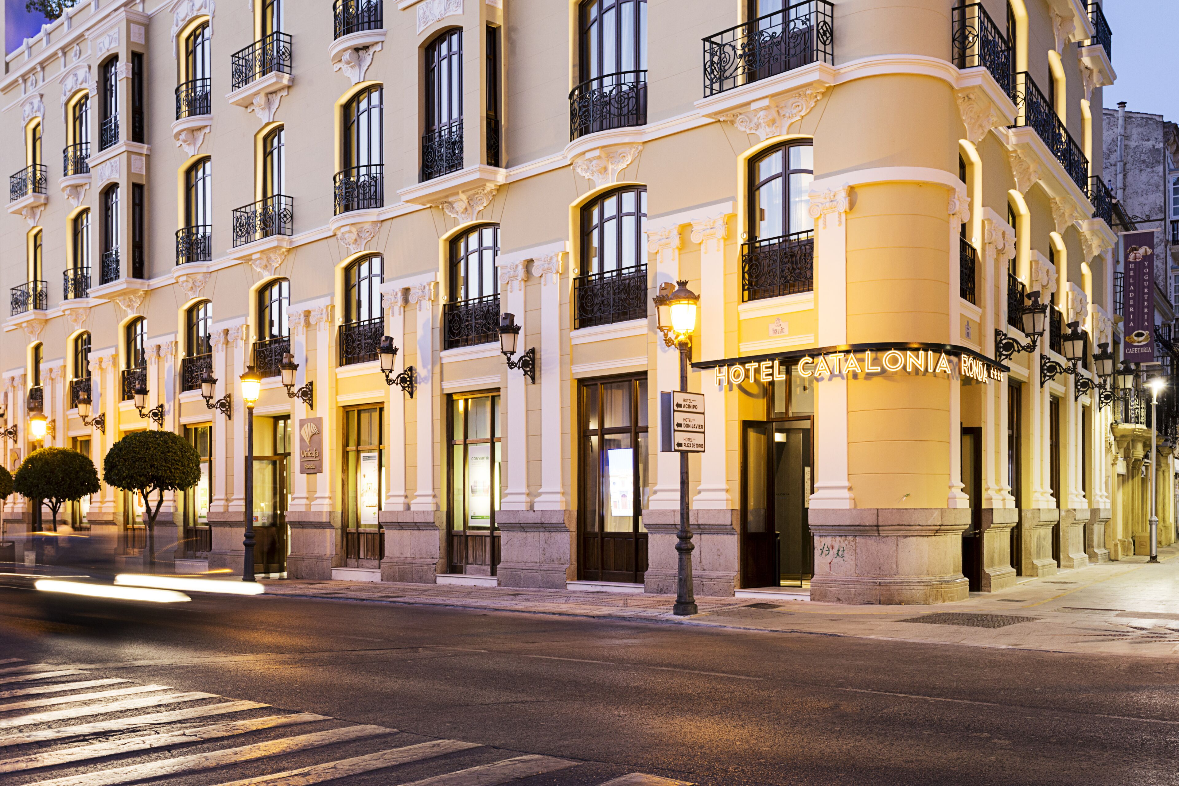 A historic hotel with ornate balconies, large windows, and classic architecture.