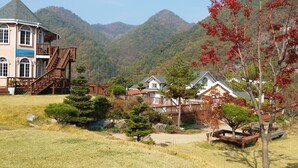 A traditional Japanese-style building with a wooden staircase and a sign indicating it is a pension. - Ecopia Pension (Pyeongchang)
