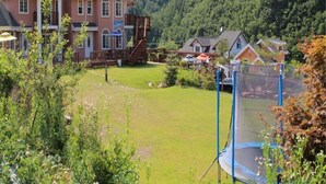 A large house with a spacious backyard, surrounded by lush green mountains. - Ecopia Pension (Pyeongchang)