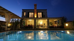 A two-story house with a swimming pool in front. - Kupina Otel (Cesme)