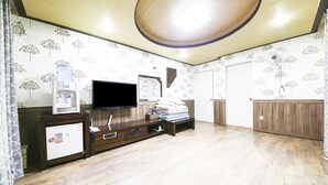 A room with a flat-screen TV, a water dispenser, a small fridge, a wooden cabinet, and a large mirror. - Venus Motel&Pension (Boryeong)