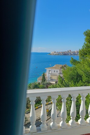 A coastal view from a balcony with white balustrades, overlooking a clear blue sea and a cityscape in the distance. - Hotel Iliria (Sarandë)