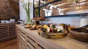 A buffet with various cheeses, fruits, and breads. - The Old Rectory (Plettenberg Bay)