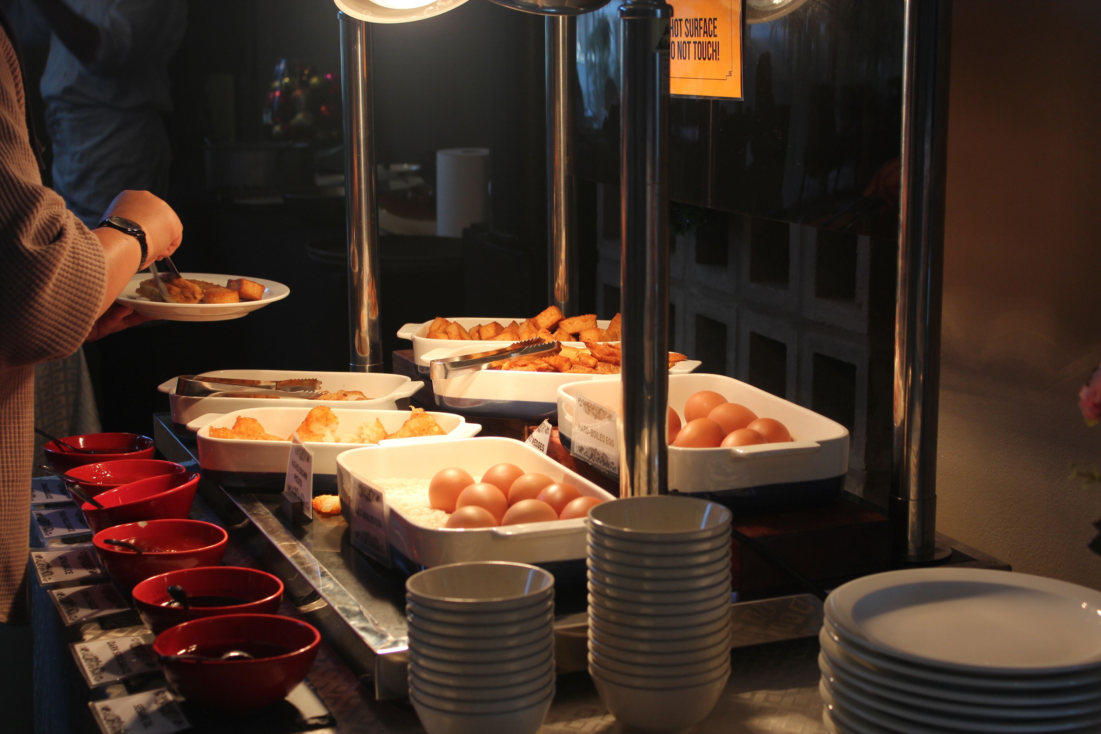 A buffet setup with various food items and bowls.