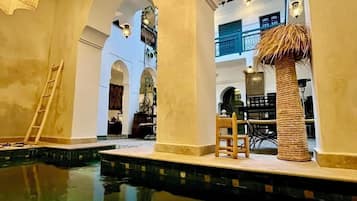 Indoor pool, open 11:00 AM to 7:00 PM, pool loungers