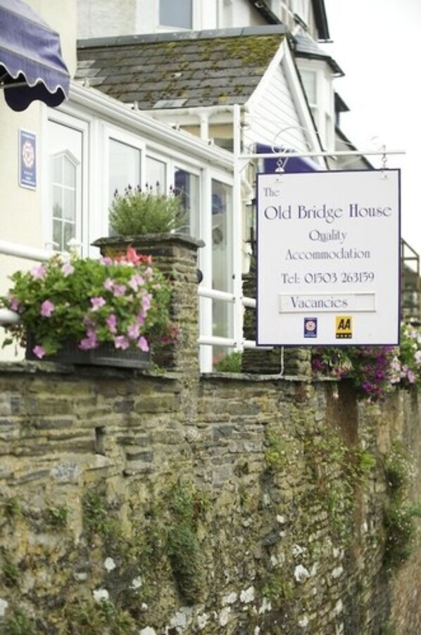 A sign for The Old Bridge House, indicating it is a quality accommodation with a telephone number and a vacancies notice.